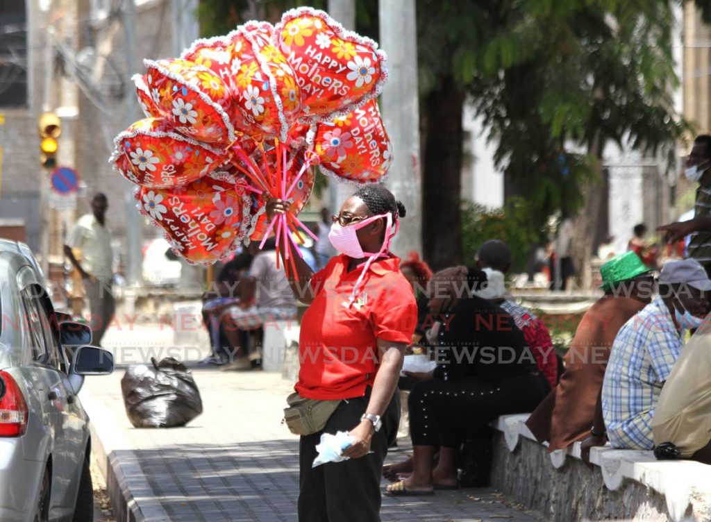 A street vendor takes a chance to sell ballons to last-minute Mother's Day shoppers along the Brian Lara Promenade, in Port of Spain. Street vending has been prohibited in the capital city as part of the restrictions for the covid19 pandemic. - Ayanna Kinsale