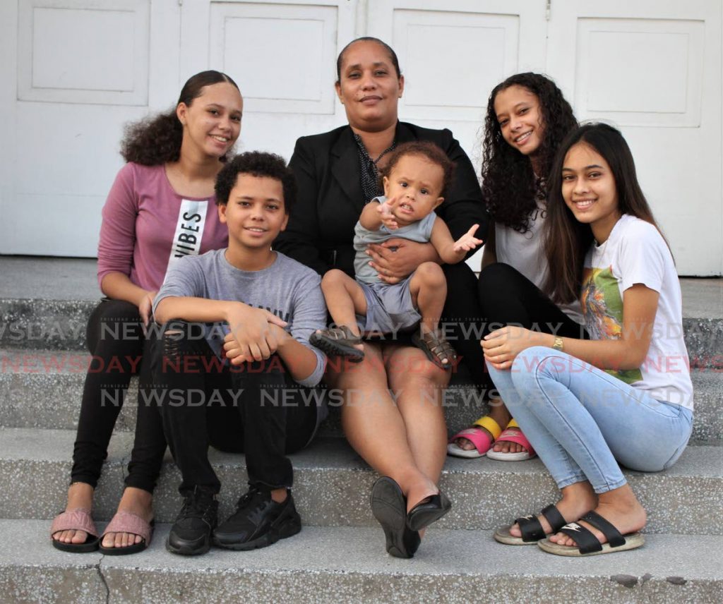 Arima Mayor Lisa Morris-Julian holds her son Jesiah. Next to her from top left are her children Xianne, Anya, Ixiah and Edin.  - Angelo Marcelle