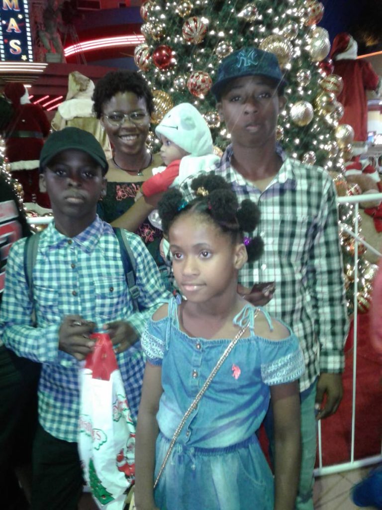  From left back, Khadeen Neptune, 18 and  14 year old Khymani Neptune.  At front, from left, Kighlon Neptune, 12 and nine-year-old Keira Shears at Movietowne, Port of Spain during Christmas holidays. - 