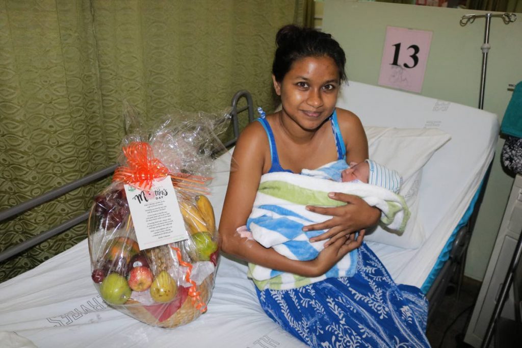 Mohini Rampersad is all smiles with her newborn baby at the Sangre Grande hospital on Sunday. - Eastern Regional Health Authority