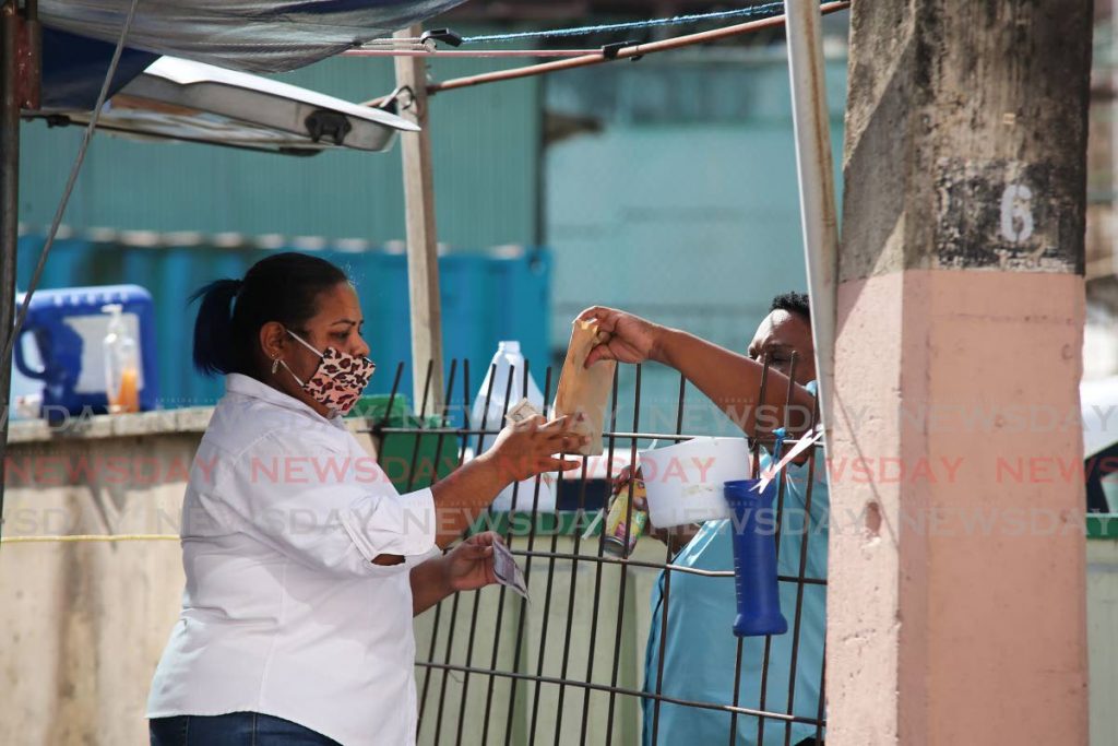 Doubles sales being conducted on Penitence street San Fernando at Ramdeo's doubles as regulations are being relaxed to allow for food sales during covid 19. - Lincoln Holder