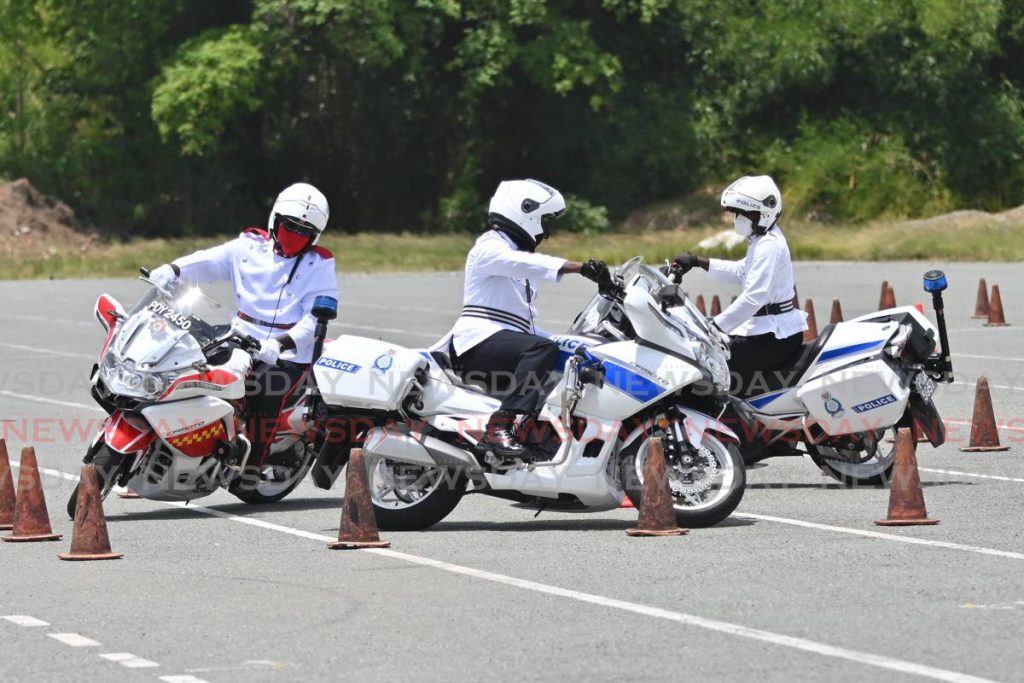 Police and fire officers show their skills at the graduation of a motorcycling course on Friday at Parade Grounds, Bacolet. PHOTO BY LEEANDRO NORAY  -  