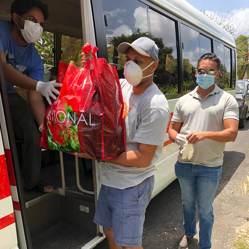Ramadhar Maharaj (left), Shawn Bedecee (centre) and Dr Ryan Harryram distribute food parcels in the Arouca area. - 