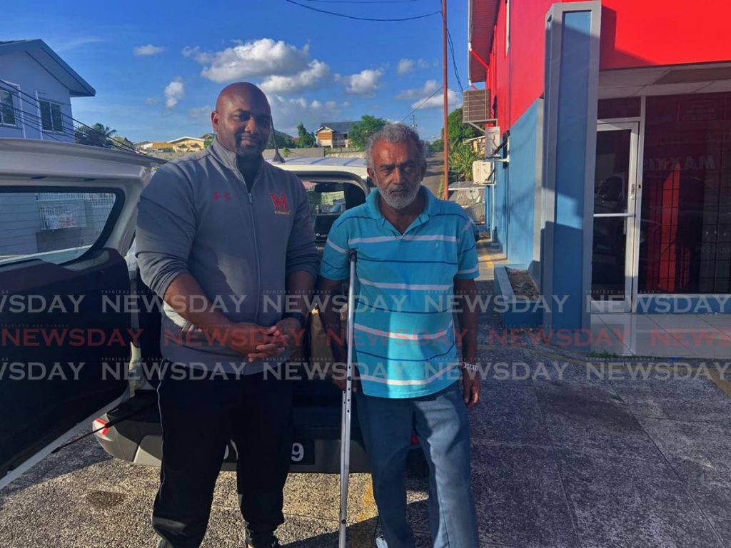 HELPING HAND: PNM candidate for San Fernando East Brian Manning, left, met with constituent Evans Rajpaul, right, to offer his assistance. PHOTO BY YVONNE WEBB - Yvonne Webb