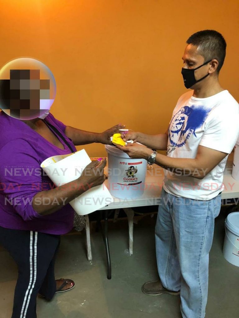ON THE GROUND: UNC's candidate for St Joseph hands out a face mask to a St Joseph resident. - 
