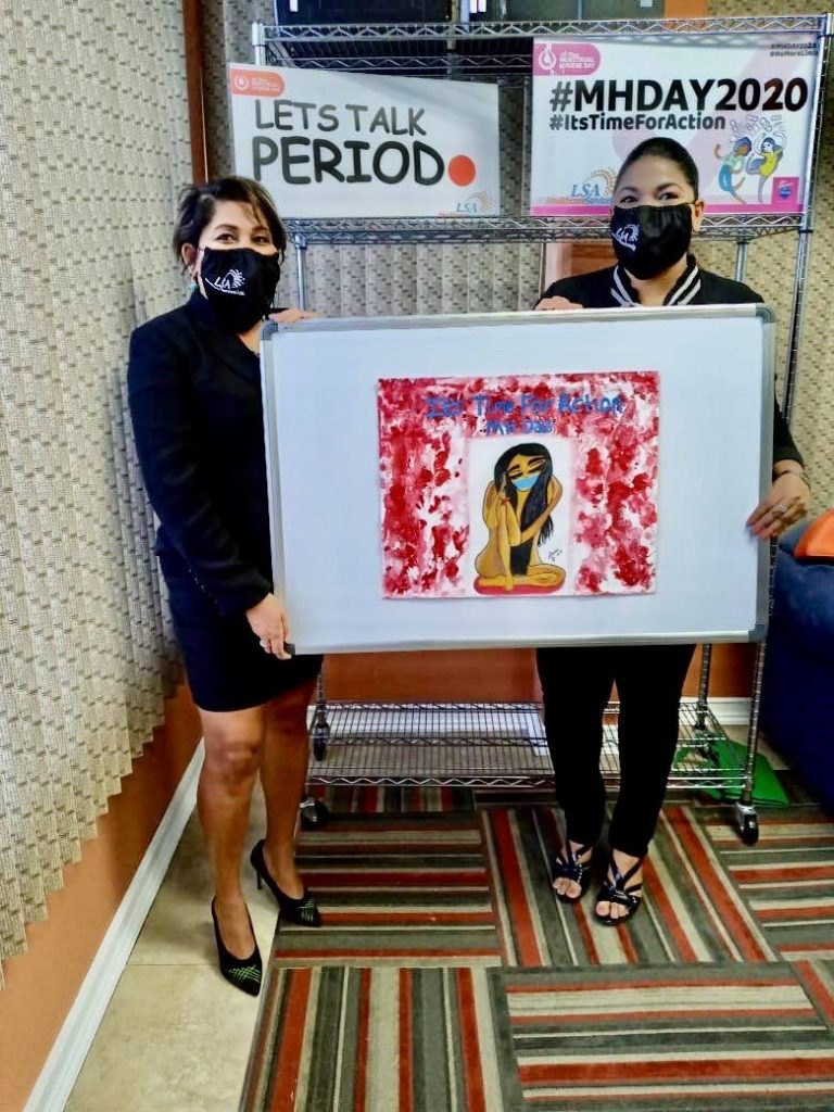 Artist Monica Ramdial presents LSA Health Care Services managing director Monica Ramdial with artwork she donated for Menstrual Hygiene Day whih is being observed today. - 