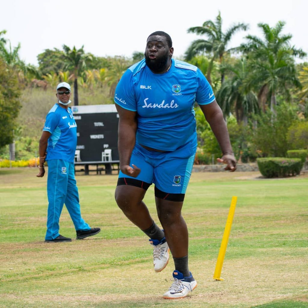 Off-spinner Rahkeem Cornwall (right) tosses a delivery while former WI captain and Women's team assistant coach Courtney Walsh looks on during a training session at the Coolidge Cricket Ground, Antigua on May 28. PHOTO COURTESY CRICKET WEST INDIES. - 