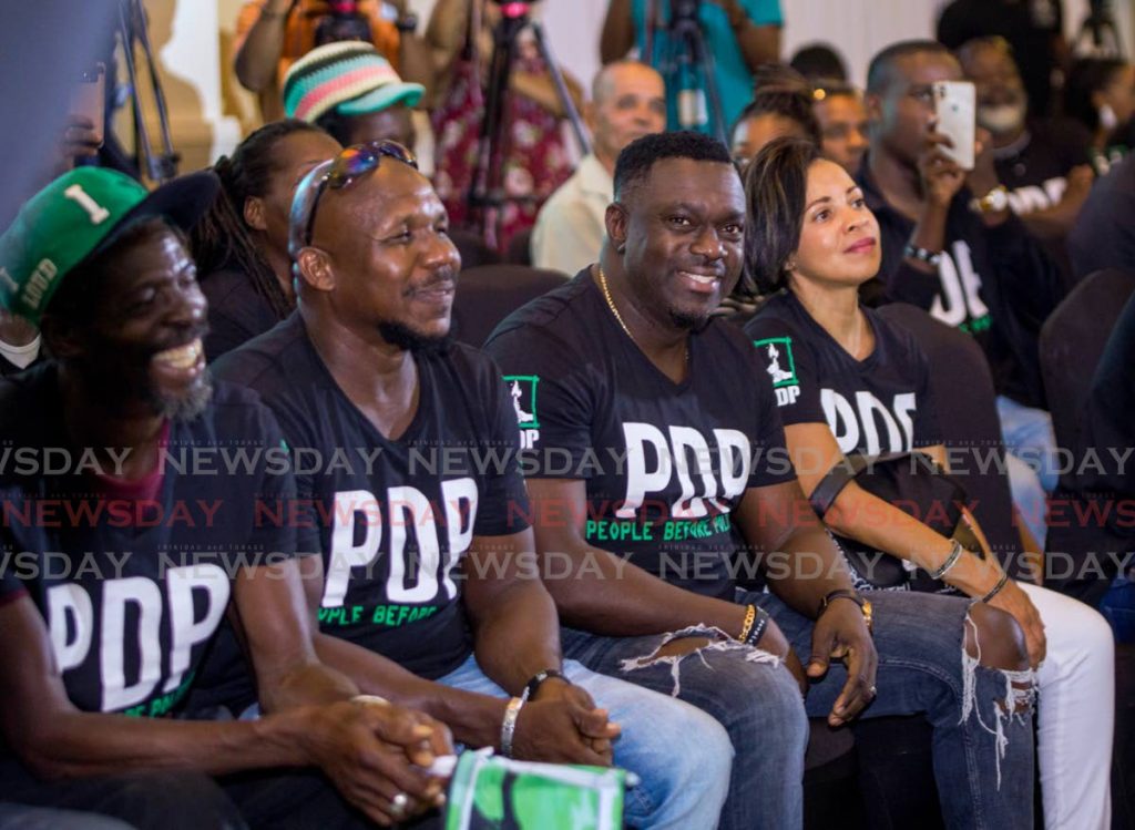 In this October 2019 file photo, PDP leader Watson, centre, with his wife and supporters during a rally at Magdalena Grand, Tobago. The party is campaigning for the 2020 general under covid19 rules.  - 