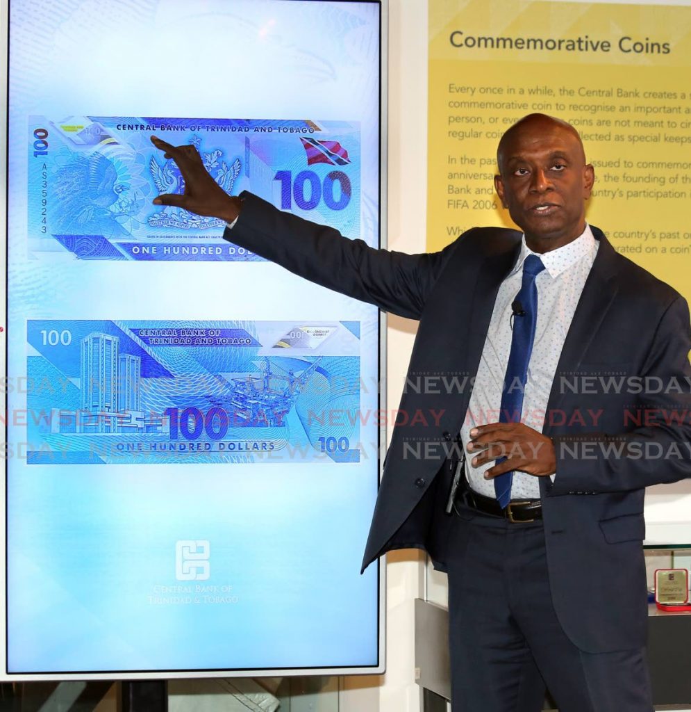 Central Bank Governor Dr Alvin Hilaire explains the features of the polymer $100 bill when it was launched in December last year. - 