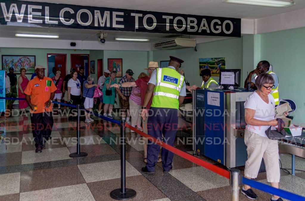 WELCOME TO TOBAGO: Visitors from the MS Volendam cruise ship get scanned as they pass through the Scarborough Port in December last year.  - 