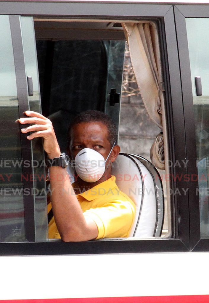 A passenger wears a mask as he travels in a maxi taxi on the Priority Bus Route in San Juan. From Monday, maxi taxis, taxis and buses will operate at 75 per cent capacity and move up to 100 per cent on June 22. File photo - 