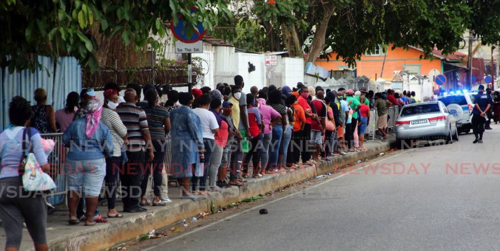 From very early in the morning on May 29, people line up on Frederic Street, Port of Spain hoping to collect a hamper from the Living Water Community. - SUREASH CHOLAI