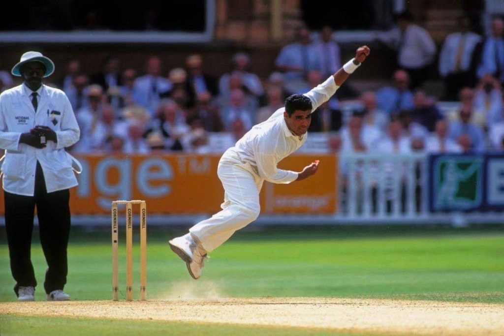 Pakistan fast bowler Waqar Younis (right) on his follow-through during a Test match against England. Also in photo is legendary Jamaican and West Indian umpire Steve Bucknor. - 