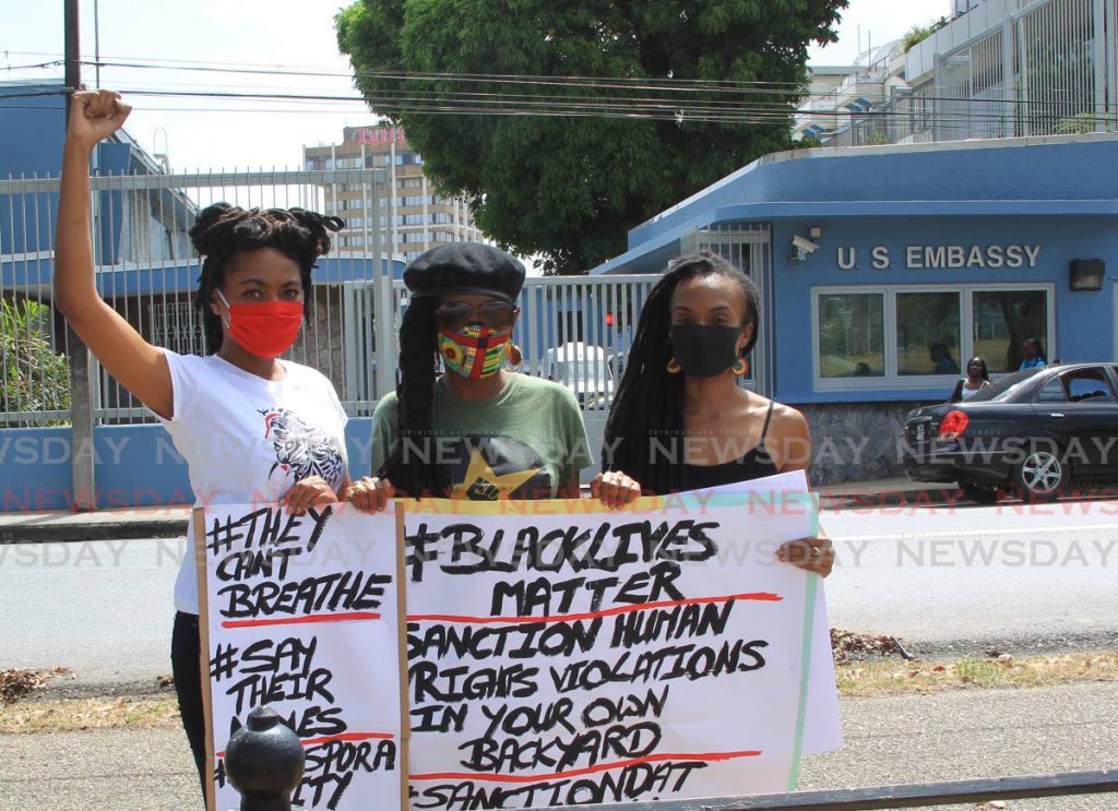 From left: activists Amanda McIntyre, Abeo Jackson and TerryAnn Roy lend support to the Black Lives Matter movement on Monday opposite the US Embassy in Port of Spain. - ROGER JACOB