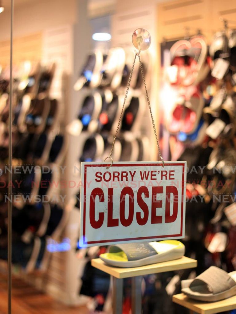 A closed sign on the door of one of the stores in Trincity Mall. As the country emerges from covid19 restrictions, people want to return to work and employers want to go back to pre-lockdown status. But the economic impact of the virus and restriction to curb its spread are making it difficult. - ROGER JACOB