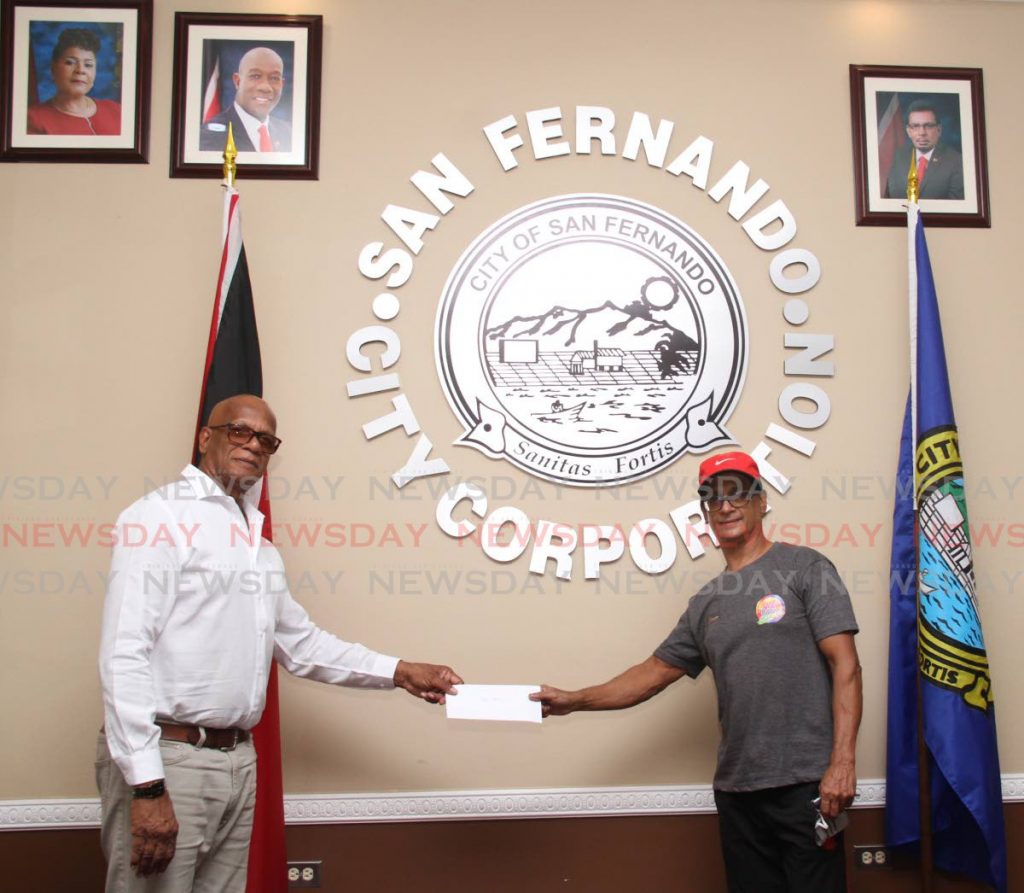 San Fernando mayor Junia Regrello presents a cheque to Wayne Hanooman of Fireworks Promotions for their third-place win in San Fernando Carnival 2020.   - Vashti Singh