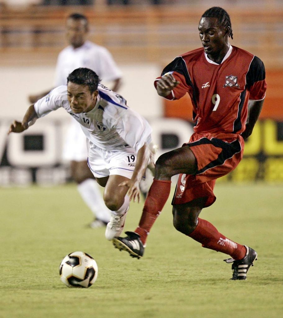 In this July 6,2005 file photo, TT’s Aurtis Whitley (R) tackles Elvis Turcios of Honduras (L) during their first match in group A of the Gold Cup at the Orange Bowl Stadium in Miami, Florida. - (AFP PHOTO)