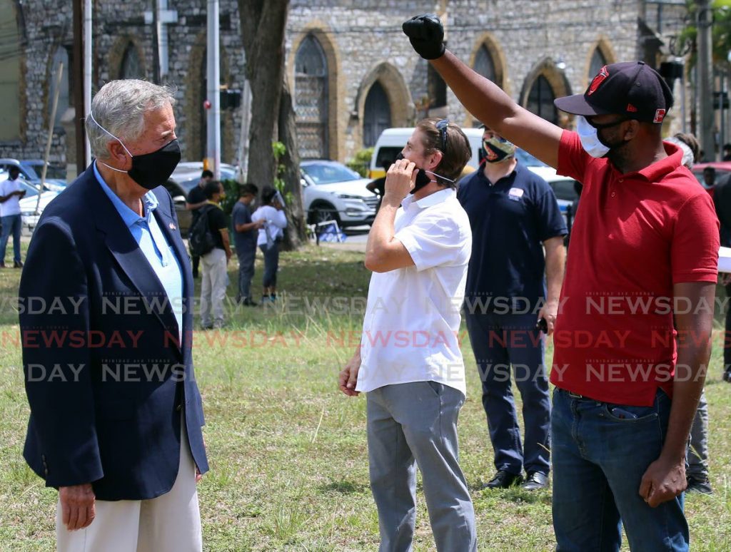I MATTTER TOO!:
US Ambassador Joseph Mondello, left, faces a Black Lives Matter protester who raises his fist during
a rally on Monday at the
QP Savannah opposite the US Embassy. PHOTO BY SUREASH CHOLAI -  