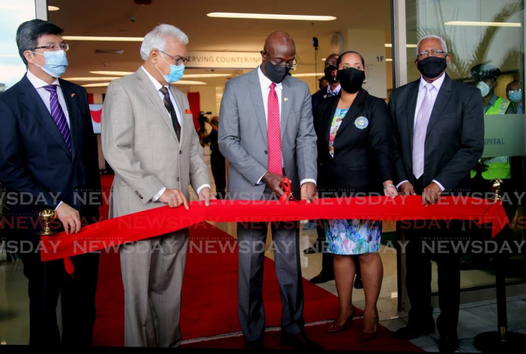 CUTTING PM: PM Dr Rowley cuts the ribbon Tuesday to open the Arima General Hospital. Also in photo from left are China’s Ambassador to TT Song Yumin, Health Minister Terrence Deyalsingh,  Arima Mayor Lisa Morris-Julien and Arima MP Anthony Garcia.  - SUREASH CHOLAI