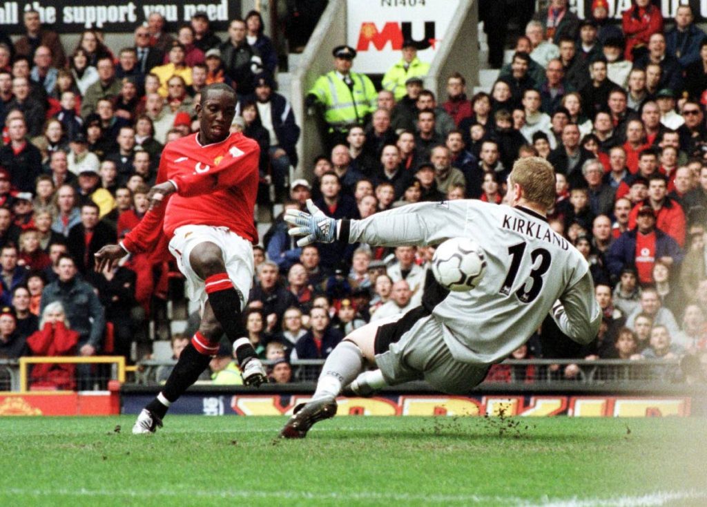 In this April 14,2001 file photo, Manchester United's striker Dwight Yorke scores the first goal vs Coventry City's goalkeeper Chris Kirkland 14 April 2001 in Manchester during their First league match. Manchester United won 4-2.  - (AFP PHOTO)