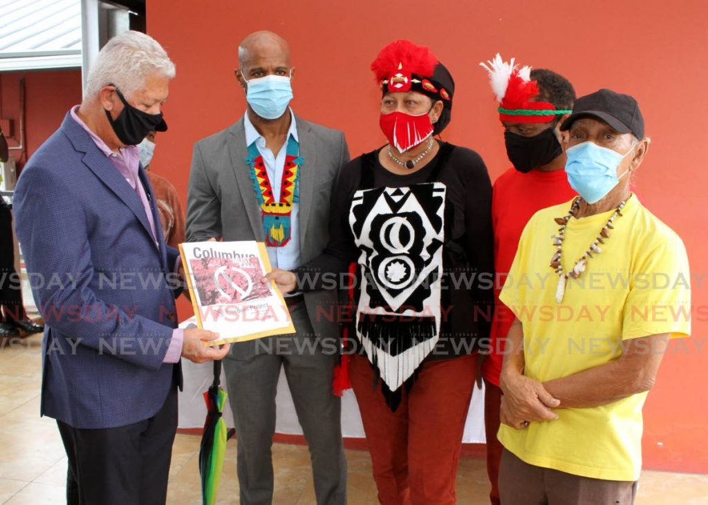 Port of Spain Mayor Joel Martinez, left, receives a petition to remove the Christopher Columbus statue from Tamarind Square, Port-of-Spain, from Queen of the Warao Nation Donna Bermudez-Bovell, centre, at City Hall, on Wednesday. Also in photo, from left, is Shabaka Kambon of Cross Rhodes Freedom Project, Anton Figeroux and Michael 'Babea' Tang Yuk. - Angelo Marcelle