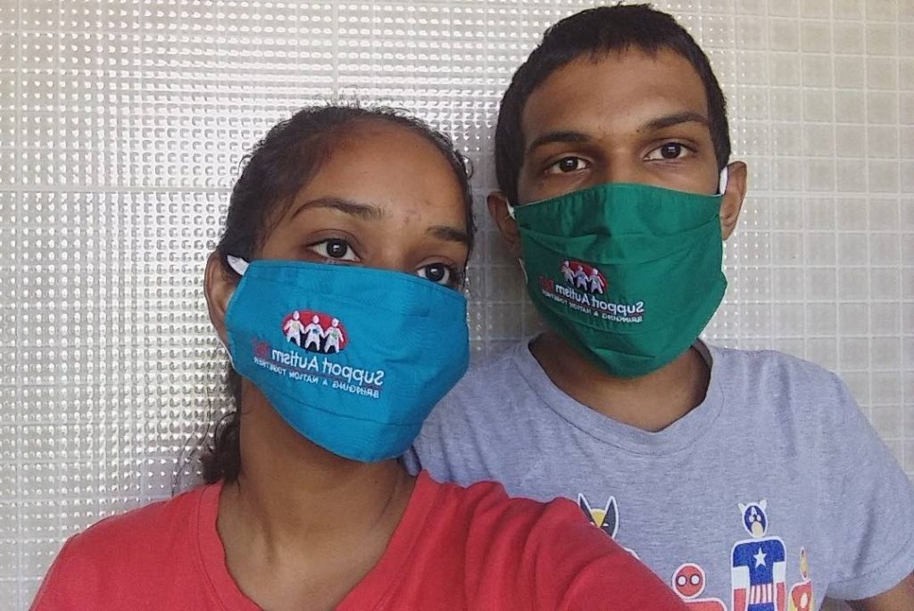 Many children with autism such as Rahal, right, cannot wear face masks for more than a few minutes. - 