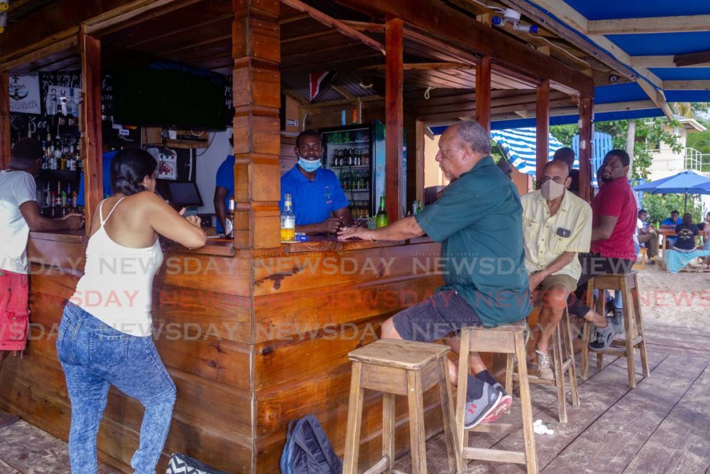 File photo: Patrons, some wearning masks, enjoy a drink at Anchors bar at Mt Irvine, Tobago on June 22. 

- DAVID REID 