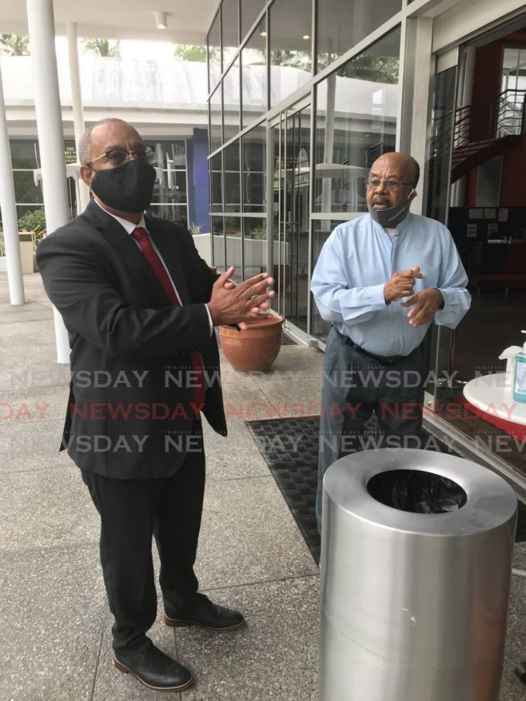 File photo of new PNM candidate for La Brea attorney Steve McClashie (left) sanitises his hands before entering Queen’s Hall, St Ann’s to be screened on June 24. Looking on is former La Brea MP Hedwige Bereaux.  
PHOTO BY JULIEN NEAVES - Julien Neaves