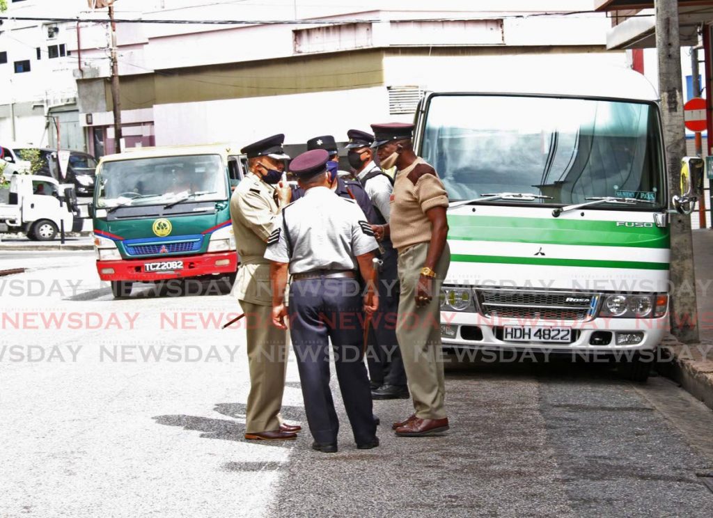 Senior Supt. Cecil Santana left  of the Trinidad and Tobago Municipal Police  South is seen speaking to his officers at lower High Street San Fernando on Wednesday 24th June . Photo by Vashti Singh  - Vashti Singh