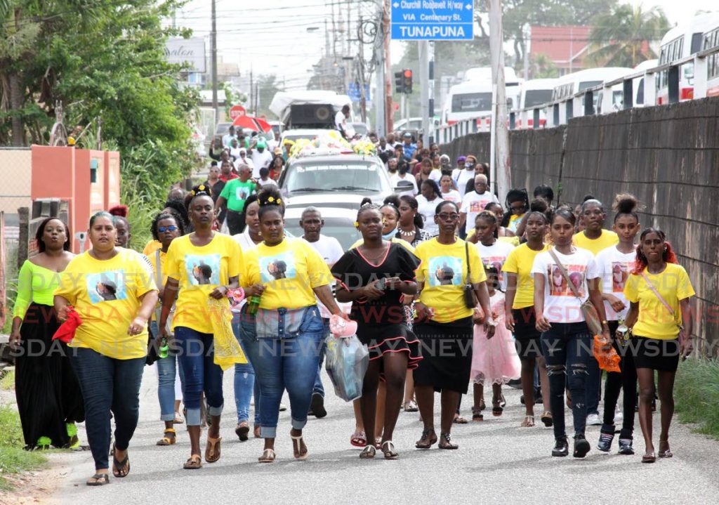 Relatives and friends lead mourners to the Tunapuna Cemetery along Bharath Street, Tunapuna.  The funeral of double murder victims Stefon McLeod and his two-year-old daughter Aniah was held at the Church of God Deliverance Centre, Maingot Road, Tunapuna. - ROGER JACOB
