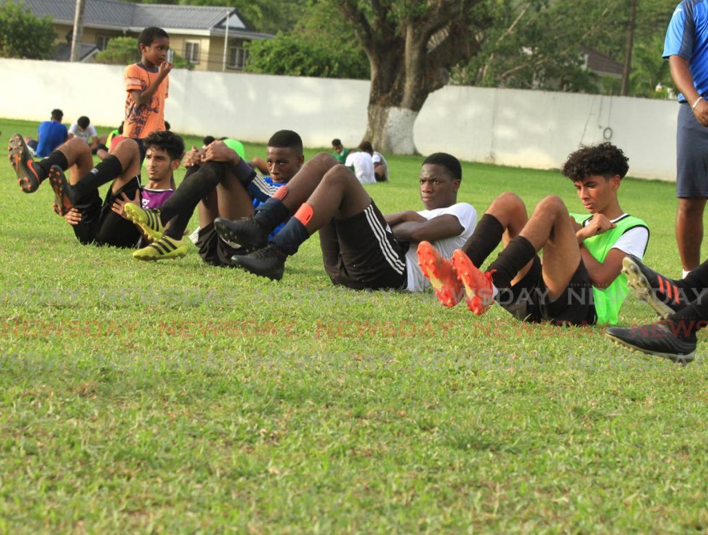 Members of the St Mary’s College Under16 football team go through some exercises during the team’s first training session since an ease on covid19 safety restrictions, at the CIC Grounds, St Clair, on Monday. - Ayanna Kinsale