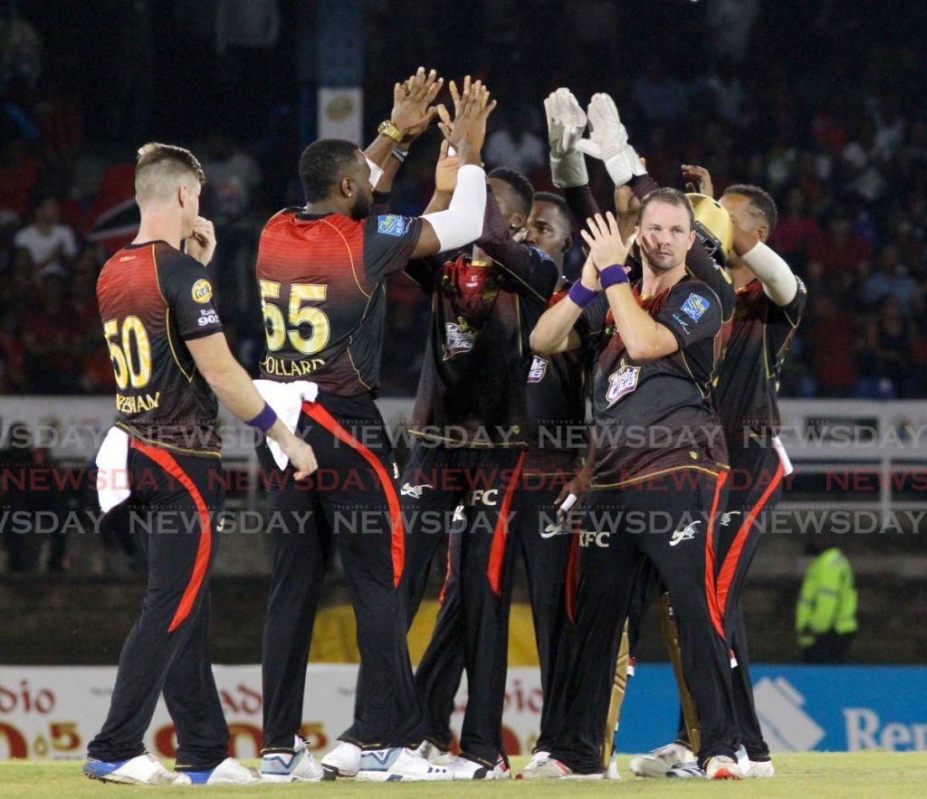 In this September 30, 2019 file photo, members of the Trinbago Knight Riders celebrate a wicket against the Guyana Amazon Warriors in a Hero Caribbean Premier League (CPL) match, at the Queen's Park Oval, St Clair. - ROGER JACOB