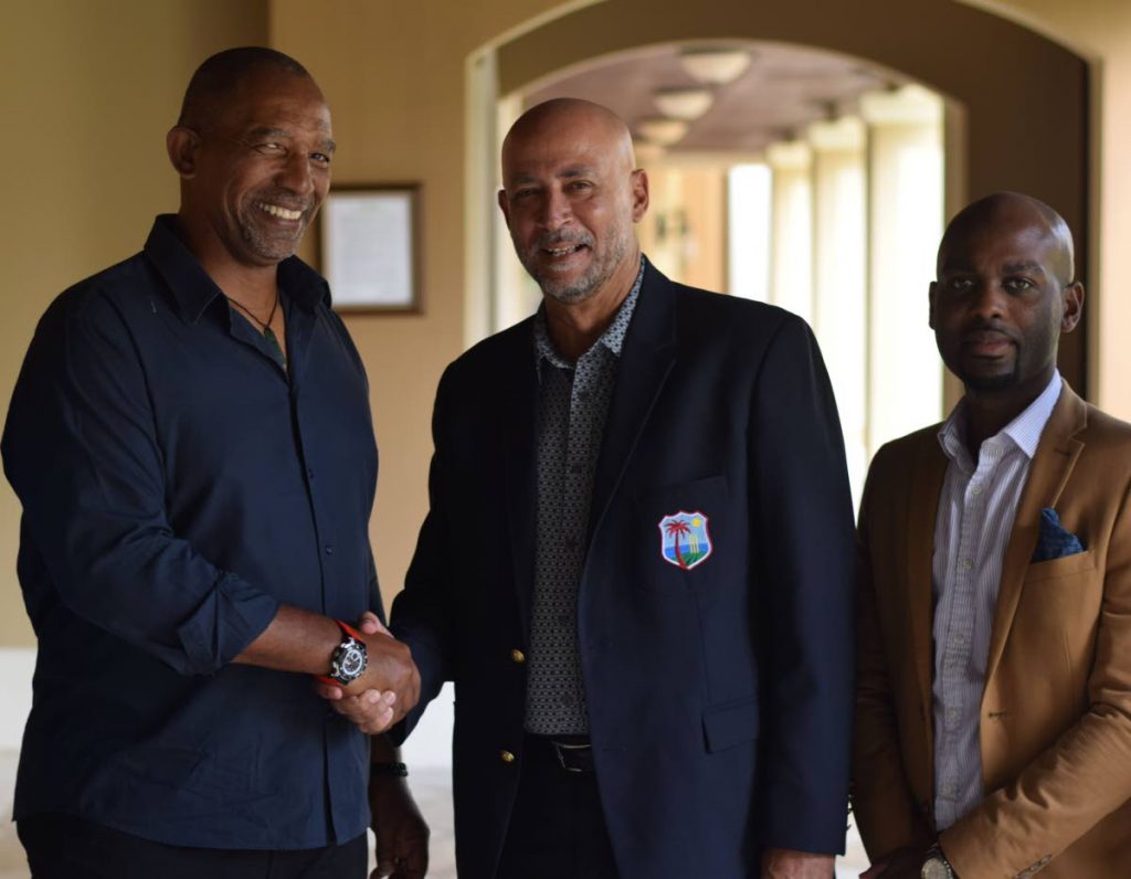 In this file photo, posted to Cricket West Indies’ twitter account, CWI president Ricky Skerritt congratulates Phil Simmons, left, after the latter was  confirmed as the new West Indies coach.  - CWI