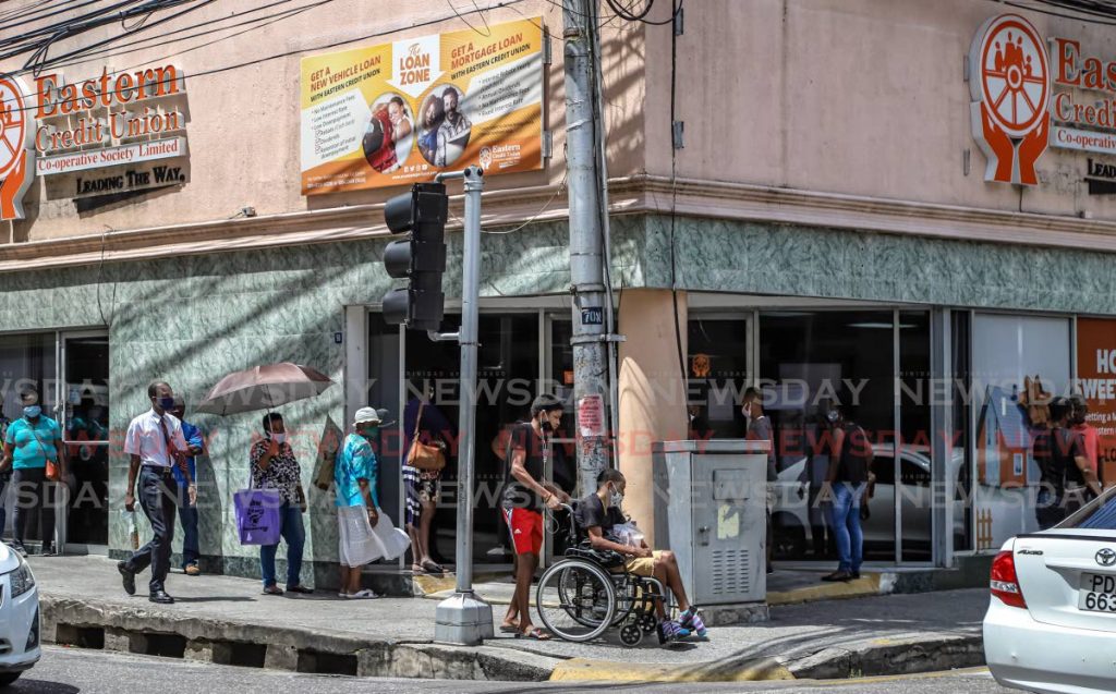 Eastern Credit Union customers wait to enter the Park Street, Port of Spain branch on June 2. The institution closed on July 2-3 due to recent protests against police brutality in the capital city. - JEFF K MAYERS