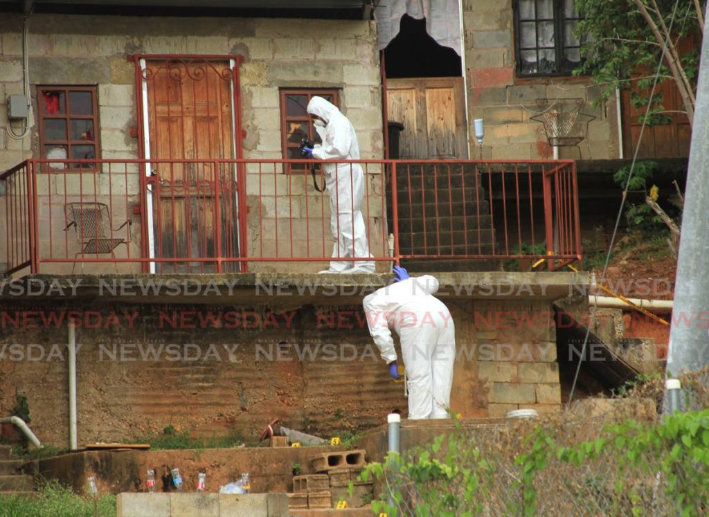 Crime scene investigators examine a house where a fatal shooting occurred in Morvant on June 6. National Security Minister Stuart Young has said there is no credibility to the UNC's crime-fighting plans. PHOTO BY AYANNA KINSALE - 