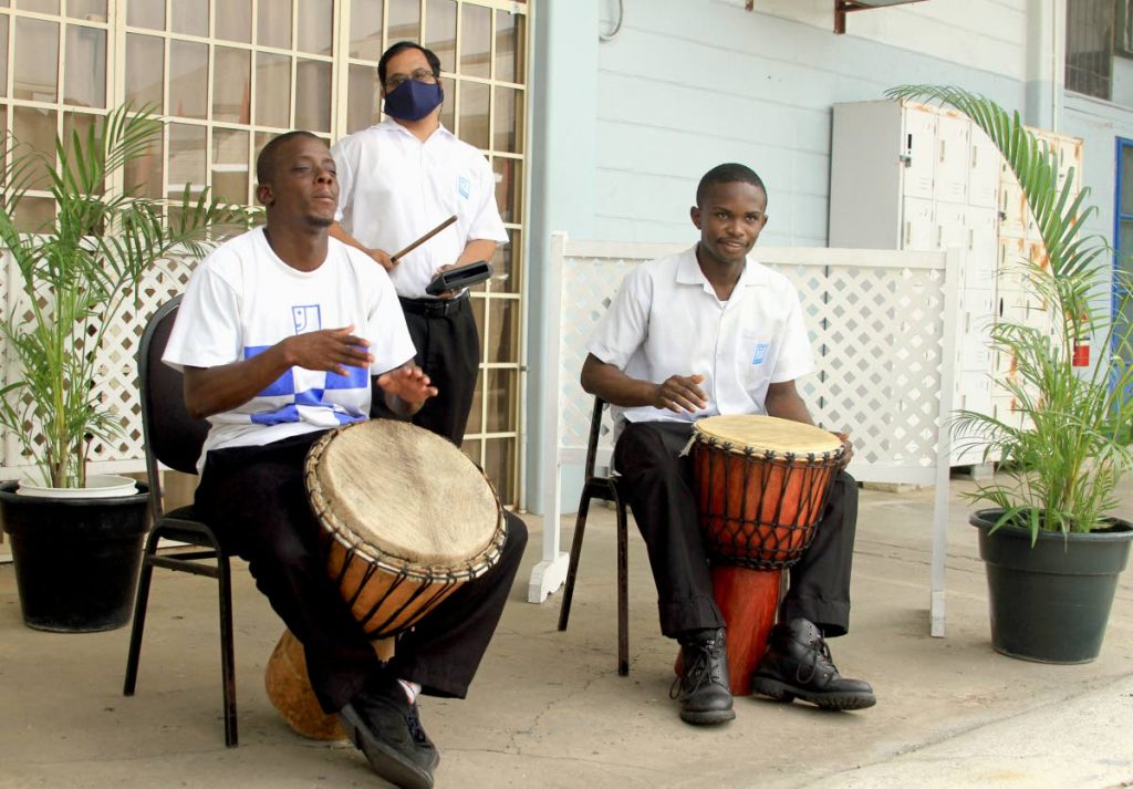 Justin Providence, from left, Sergio Williams and Daniel Haynes perform during the Connecting You Programme launch at Goodwill Industries, Fitzblackman Drive, Woodbrook. Digicel donated tablets to students so they can continue learning while at home during while schools remains closed due to the covid19 restrictions on June 26. Social distancing and a shift system will be implemented at the school when the school year begins on September 1. PHOTO BY AYANNA KINSALE - 