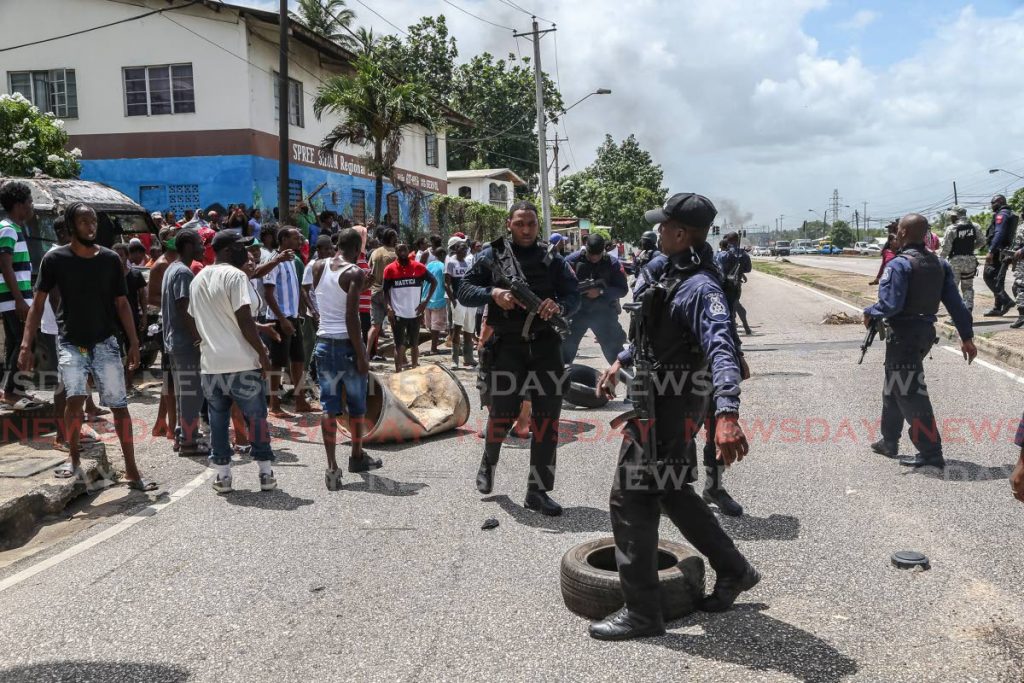Police respond to protests by residents of east Port of Spain on June 30. PHOTO BY JEFF MAYERS - Jeff Mayers