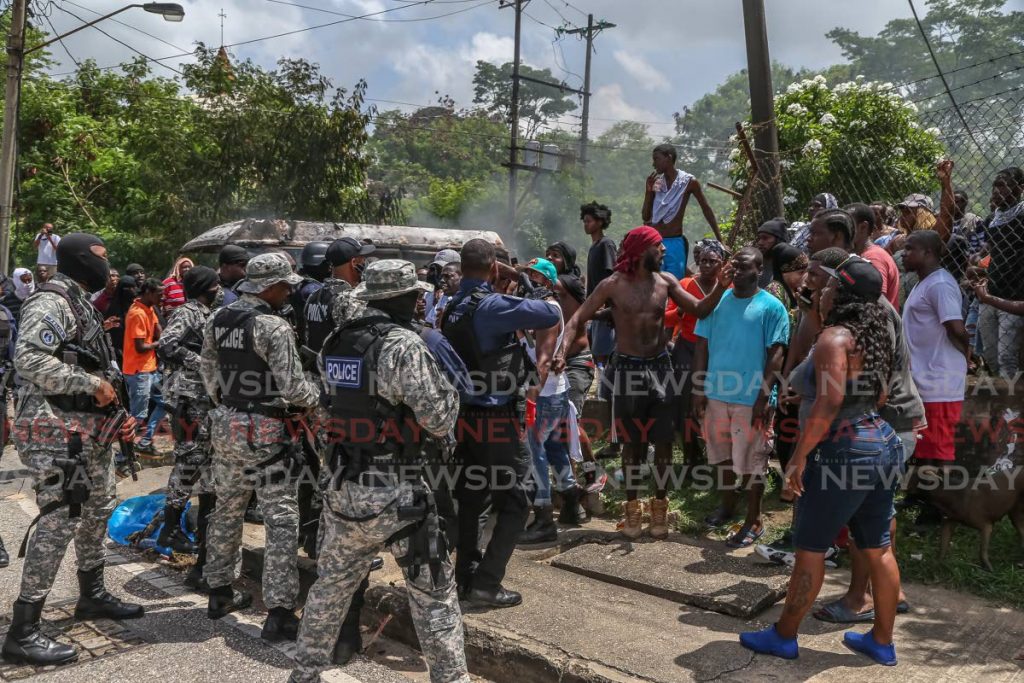Protesters face of with police during protests in East Port  of Spain last week. - Jeff Mayers