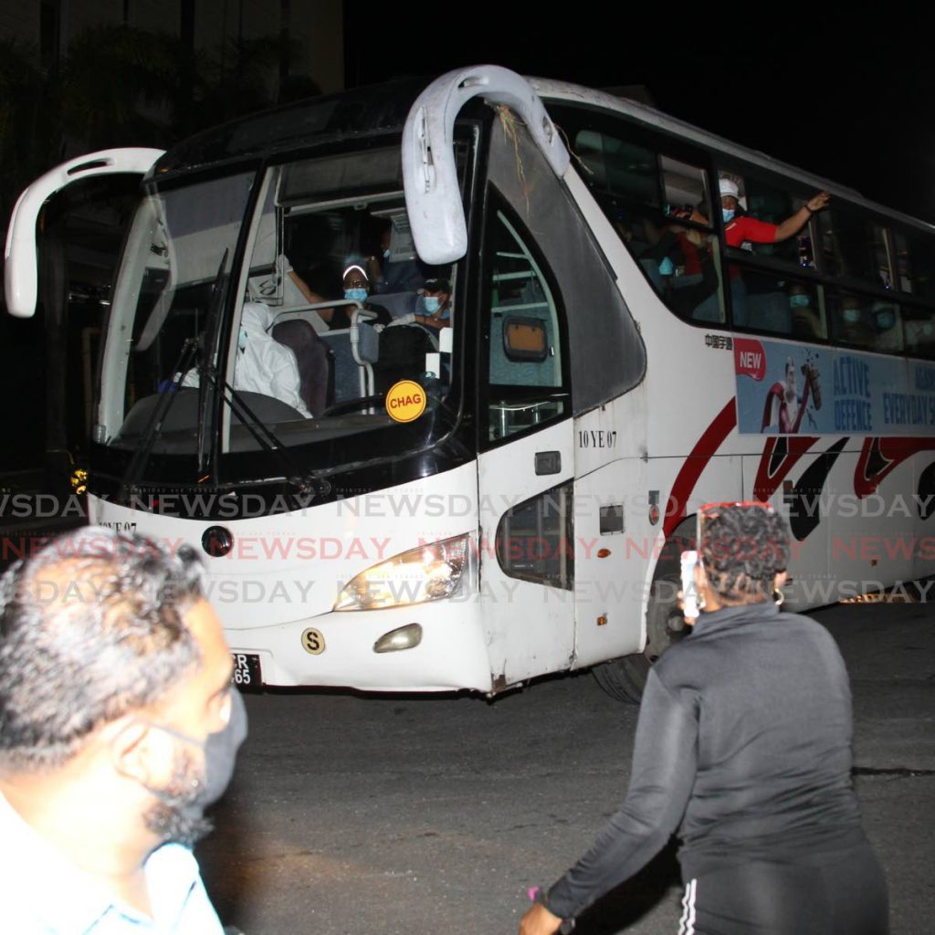 Friends and relatives of 307 cruise ship crew members that were quarantined on the Enchantment of the Seas cheer for the group as they were transported from the ship to on-land quarantine facilities on Tuesday night. - Roger Jacob