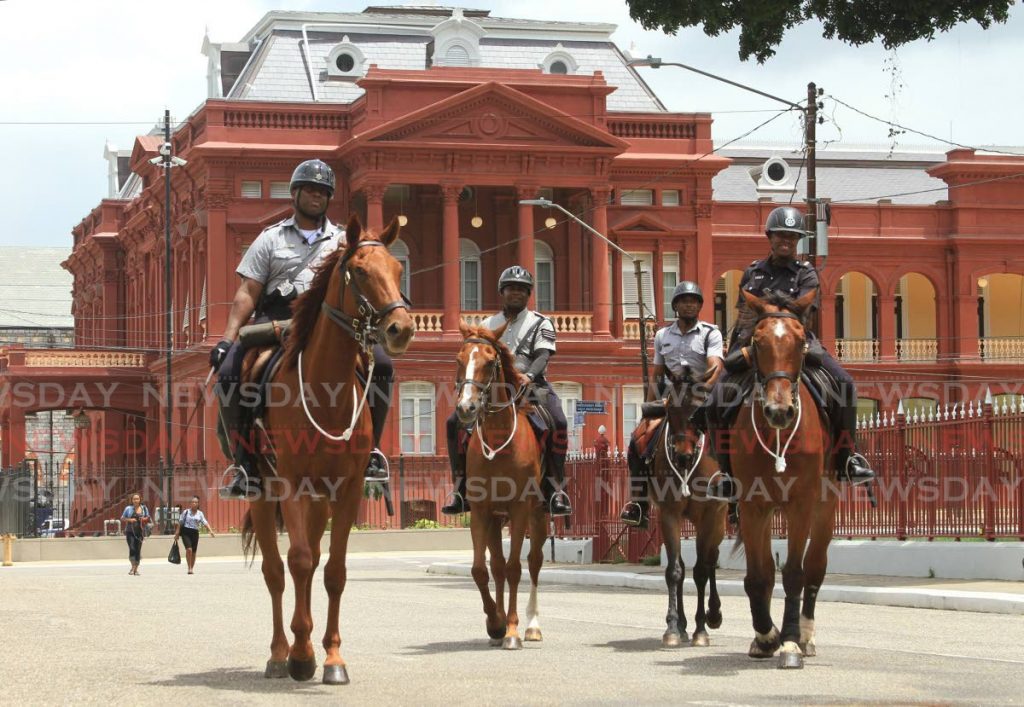 Officers of the Mounted Branch ride their horses along Hart Street, Port of Spain. - Ayanna Kinsale