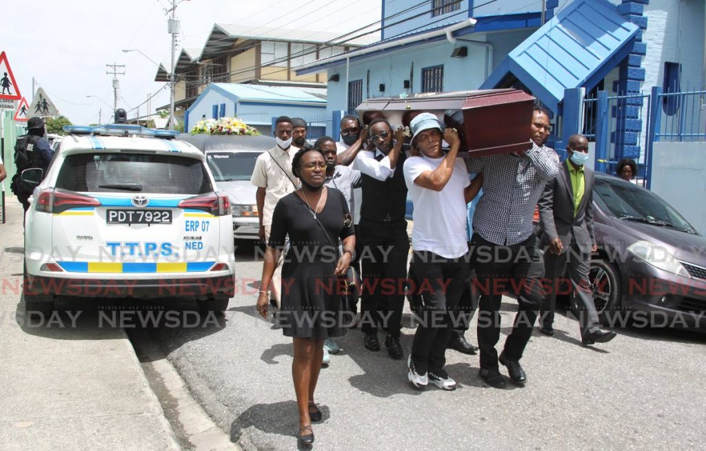 Mourners carry a casket with the body of Joel Jacobs, one of the three killed by police, past the San Juan Police Station on their way to the San Juan 
Cemetery during Jacobs’ funeral - ROGER JACOB