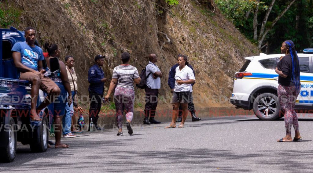 Relatives of murder victim Avalion Nurse as they gathered at the scene where his body was found on Saturday at Providence Road, Les Coteaux, Tobago. - David Reid