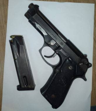The gun and a magazine with 13 rounds ammunition found at a house in Arima on Thursday.    - 