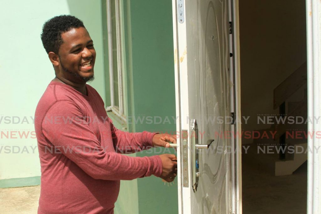 Marcus Gibbs opens the door to his new HDC townhouse at Cashew Gardens, Chaguanas, on July 9. - Ayanna Kinsale
