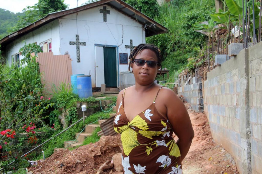 Afeisha Caballero stands before her home in Champs Fleurs. Afeisha says she was 11 when she learned her mother Lorraine Caballero was killed in the Red House during the July 1990 attempted coup.  - SUREASH CHOLAI