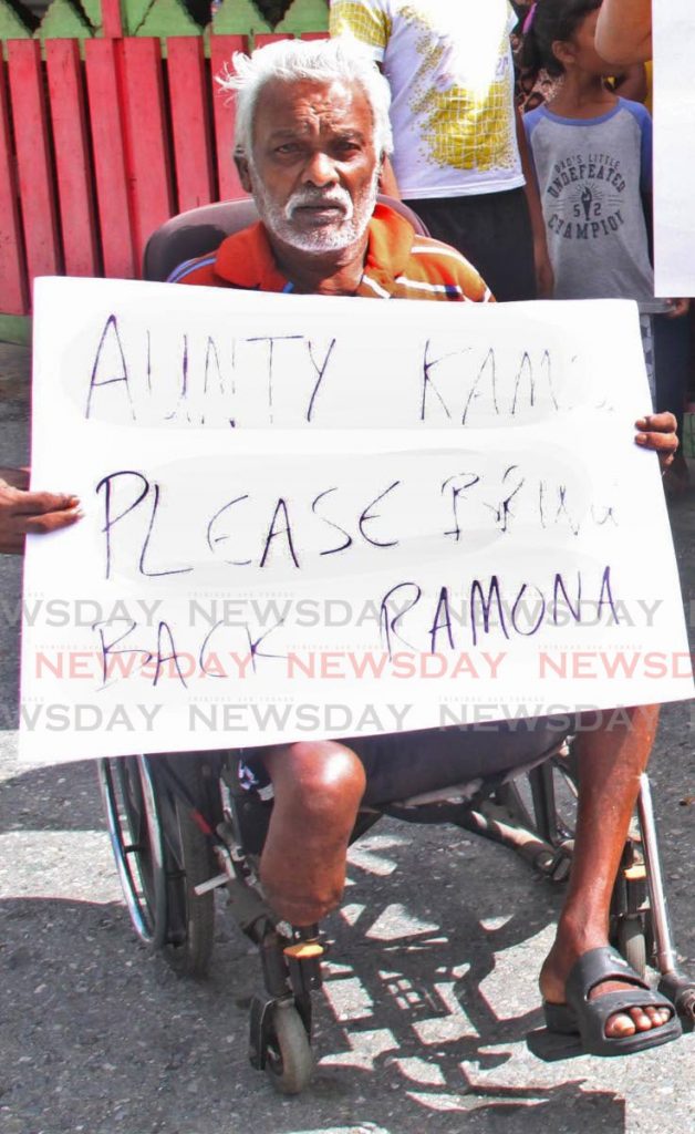 A resident of Bank Village, Carapichaima, protests on Sunday for Opposition Leader Kamla Persad Bissessar to bring back the outgoing MP Ramona Ramdial.  - Vashti Singh