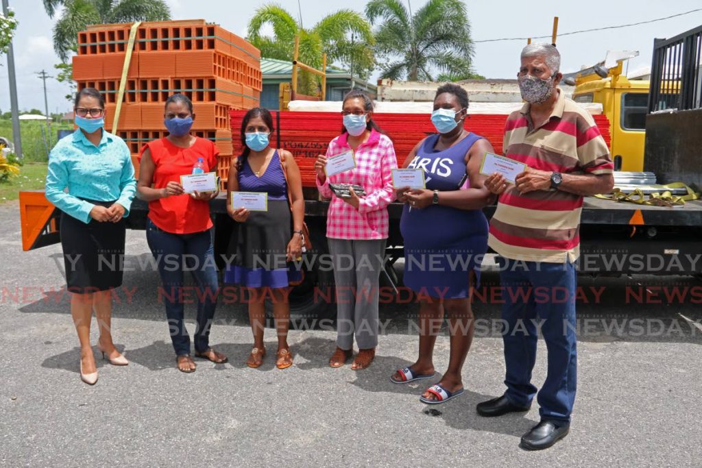 Chaguanas Mayor and UNC candidate for Chaguanas East Vandana Mohit gives out vouchers for home building materials at the Cunupia Market on Monday. - Marvin Hamilton