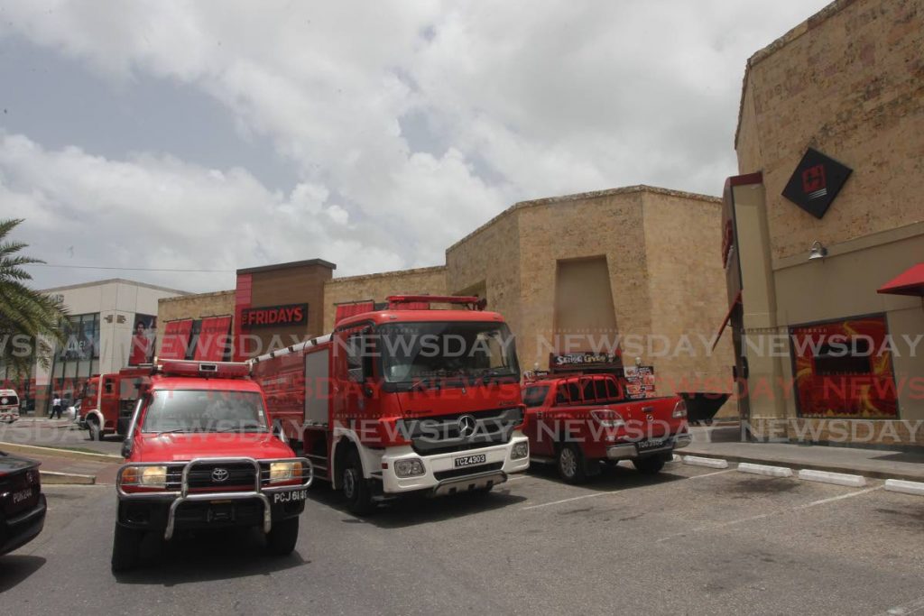 Fire officers from the Chaguanas  fire station responding to a fire at the  food court  located at Price Plaza Chaguanas.

Lincoln Holder / NEWSDAY  - Lincoln Holder