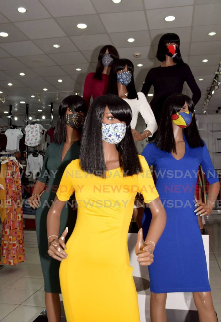 Fashionably safe: These mannequins make wearing masks look chic in the showcase at 212 Location Blaanix on Frederick street Port-of-Spain, on Tuesday. - Vidya Thurab