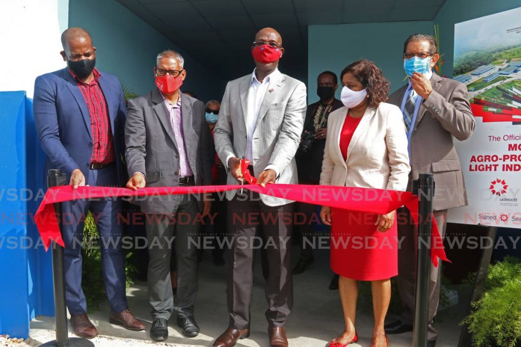 Prime Minister Dr Keith Rowley, joined by former Moruga/Tableland MP Dr Lovell Francis (from left), Agriculture Minister Clarence Rambharat, and Trade Minister Paula Gopee-Scoon, cuts the ribbon to open the Moruga Agro-Processing and Light Industrial Park on July 14. In an election year, the opening of facilities is one of the issues that raises concerns of unfair advantage by a ruling administration and prompts calls for campaign finance reform.  - Marvin Hamilton